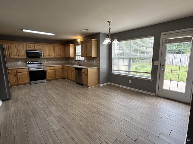 103 Lattice Bnd, Bonaire, GA 31005 - kitchen with stainless steel appliances, a sink, a chandelier, backsplash, and light countertops