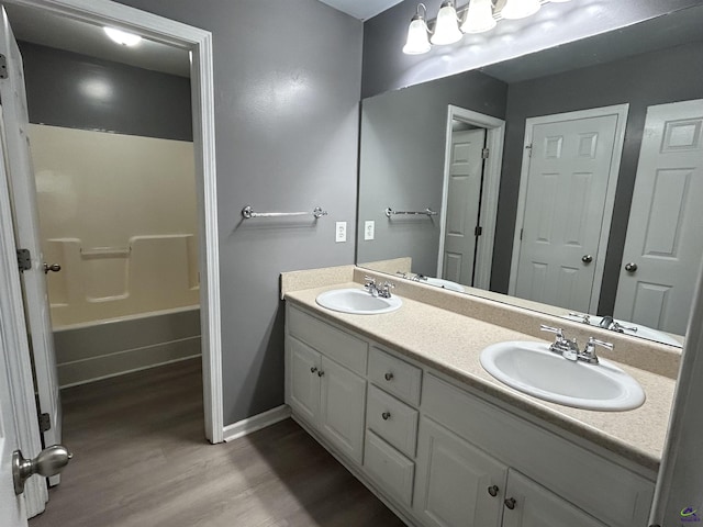 103 Lattice Bnd, Bonaire, GA 31005 - bathroom featuring double vanity, wood finished floors, baseboards, and bathing tub / shower combination