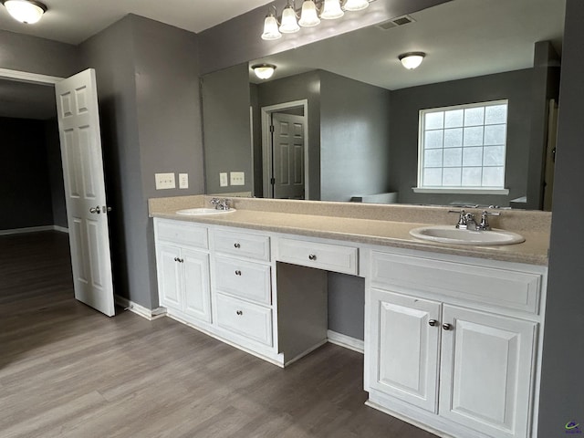 103 Lattice Bnd, Bonaire, GA 31005 - bathroom with double vanity, wood finished floors, and baseboards
