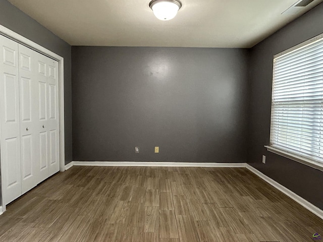 103 Lattice Bnd, Bonaire, GA 31005 - unfurnished bedroom with wood finished floors, a closet, and baseboards