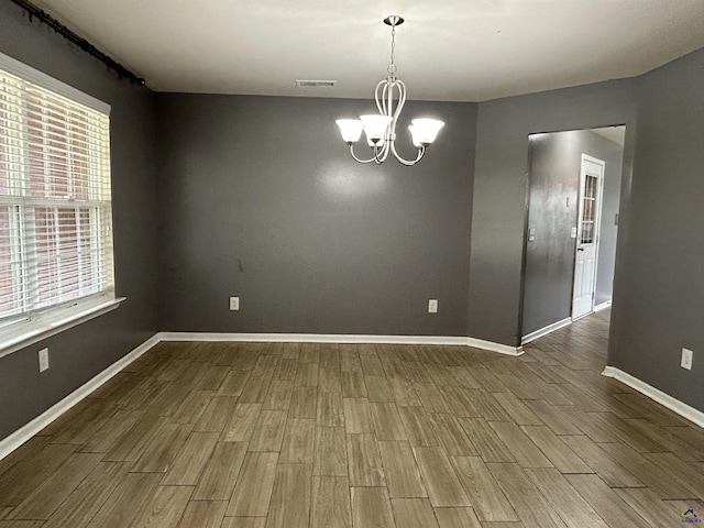 103 Lattice Bnd, Bonaire, GA 31005 - spare room featuring a chandelier, wood finished floors, and baseboards