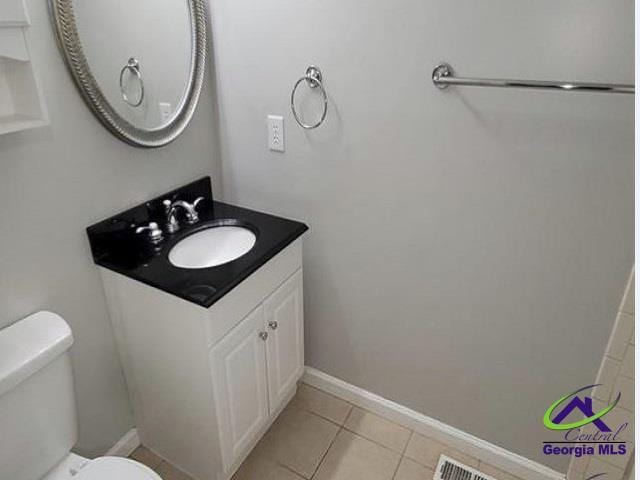 115 Friar Tuck Ave, Warner Robins, GA 31088 - bathroom with toilet, vanity, tile patterned floors, and baseboards