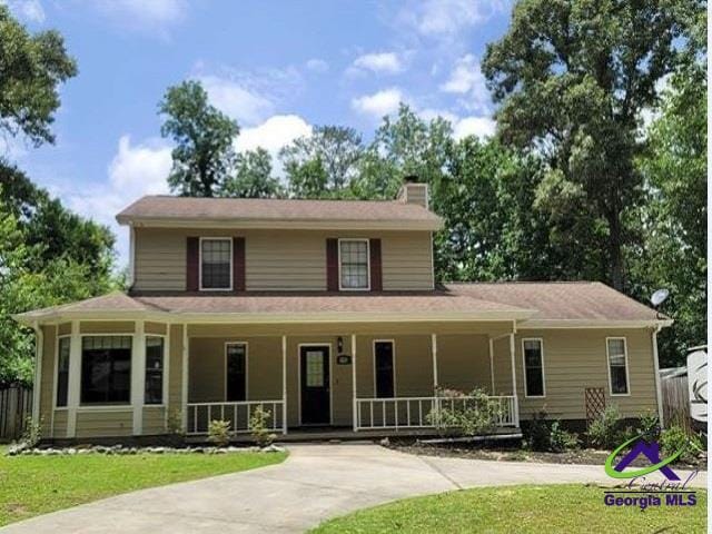 115 Friar Tuck Ave, Warner Robins, GA 31088 - farmhouse-style home with a chimney, a porch, and a front yard