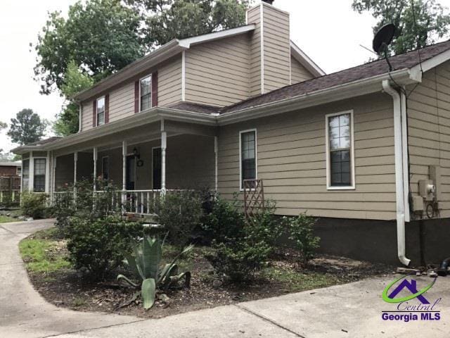 115 Friar Tuck Ave, Warner Robins, GA 31088 - view of side of home featuring covered porch and a chimney
