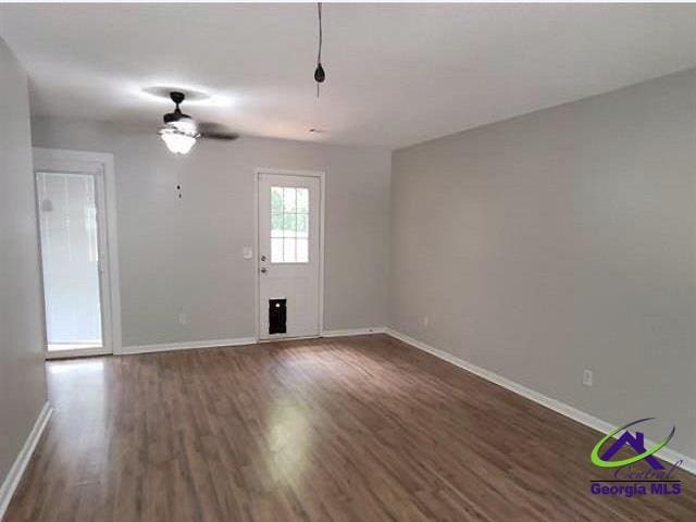 115 Friar Tuck Ave, Warner Robins, GA 31088 - spare room with baseboards, dark wood-style floors, and ceiling fan