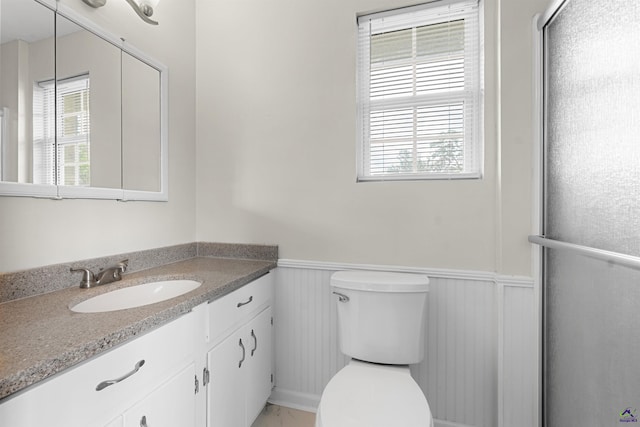 202 Kimberly Rd, Warner Robins, GA 31093 - bathroom with a wainscoted wall, vanity, toilet, and a shower with door