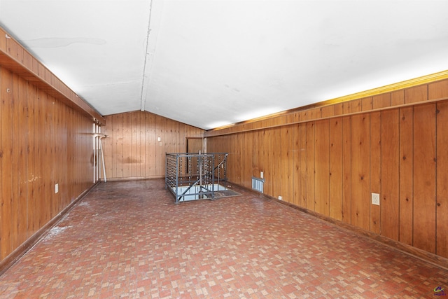 202 Kimberly Rd, Warner Robins, GA 31093 - empty room featuring wooden walls, vaulted ceiling, and baseboards