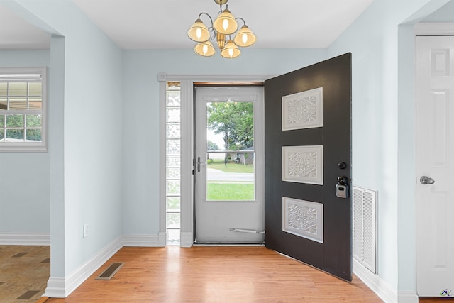 202 Kimberly Rd, Warner Robins, GA 31093 - entrance foyer featuring healthy amount of natural light, a chandelier, baseboards, and light wood-type flooring