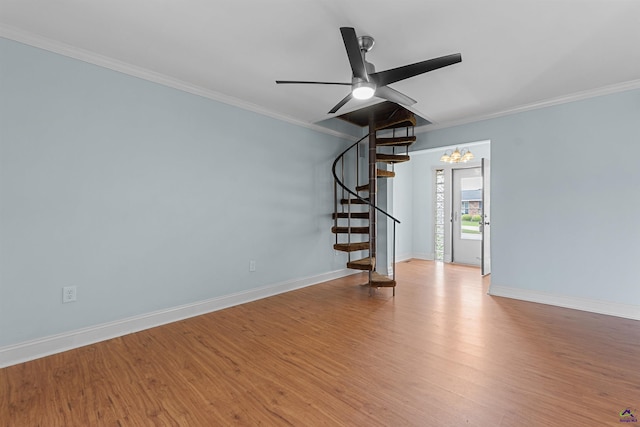 202 Kimberly Rd, Warner Robins, GA 31093 - empty room with stairway, crown molding, wood finished floors, a ceiling fan, and baseboards