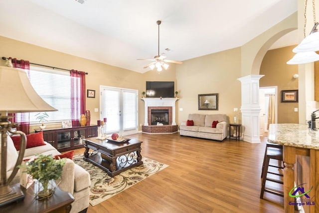 201 Loudon Hill Dr, Warner Robins, GA 31088 - living room with a fireplace, arched walkways, a ceiling fan, high vaulted ceiling, and wood finished floors