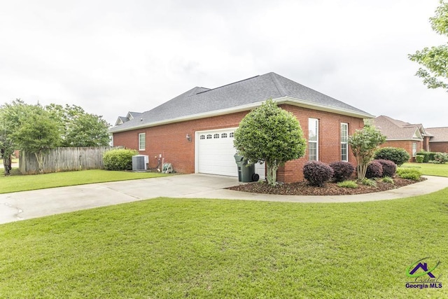 201 Loudon Hill Dr, Warner Robins, GA 31088 - view of side of home with central AC unit, brick siding, driveway, an attached garage, and a shingled roof