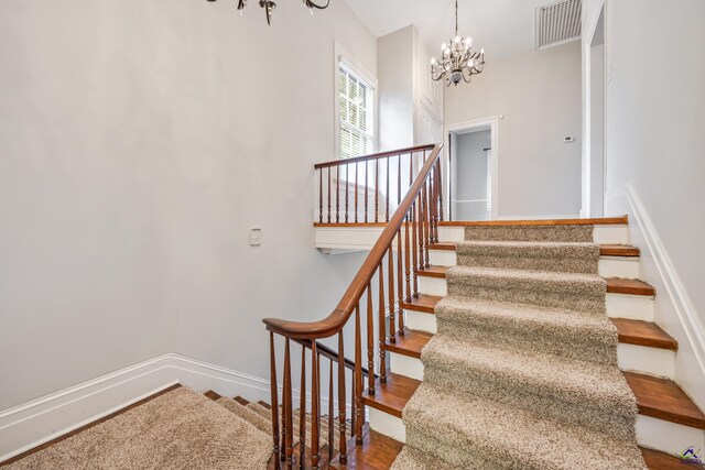 938 Park Pl, Macon, GA 31201 - stairway with a chandelier, wood finished floors, and baseboards