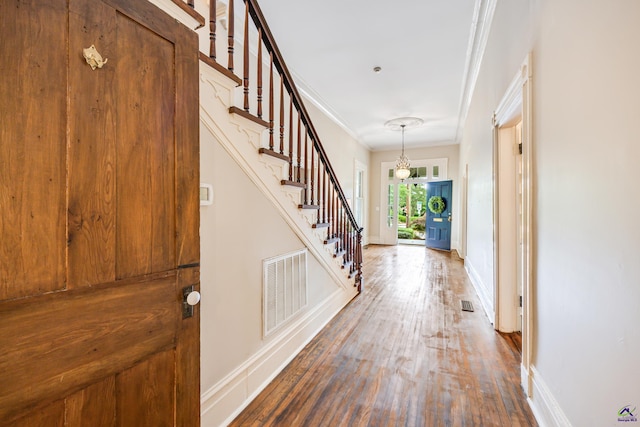 938 Park Pl, Macon, GA 31201 - entrance foyer with ornamental molding, baseboards, stairway, wood finished floors, and a chandelier
