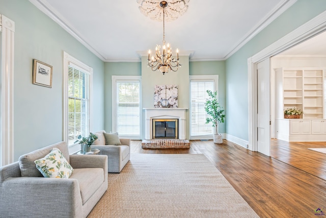 938 Park Pl, Macon, GA 31201 - living room featuring a chandelier, wood finished floors, a brick fireplace, crown molding, and baseboards