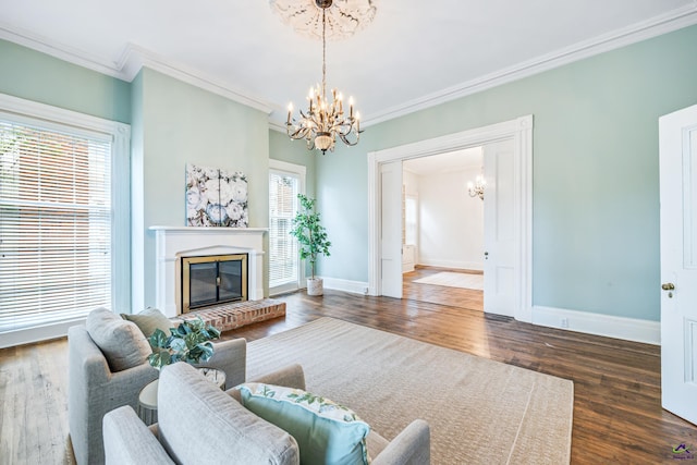 938 Park Pl, Macon, GA 31201 - living area with a chandelier, ornamental molding, baseboards, a fireplace, and wood finished floors