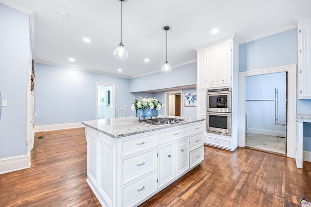 938 Park Pl, Macon, GA 31201 - kitchen with stainless steel appliances, wood finished floors, a center island, baseboards, and ornamental molding