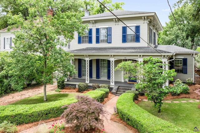 938 Park Pl, Macon, GA 31201 - italianate house featuring covered porch, a shingled roof, a front lawn, and a chimney