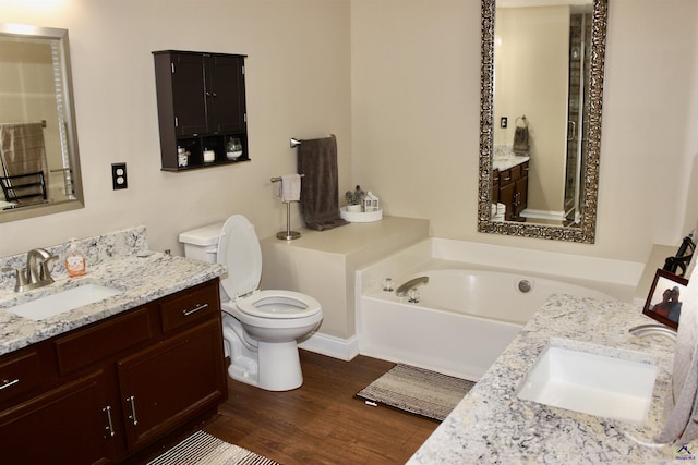 303 Shane, Perry, GA 31069 - bathroom featuring vanity, toilet, wood finished floors, and a bath