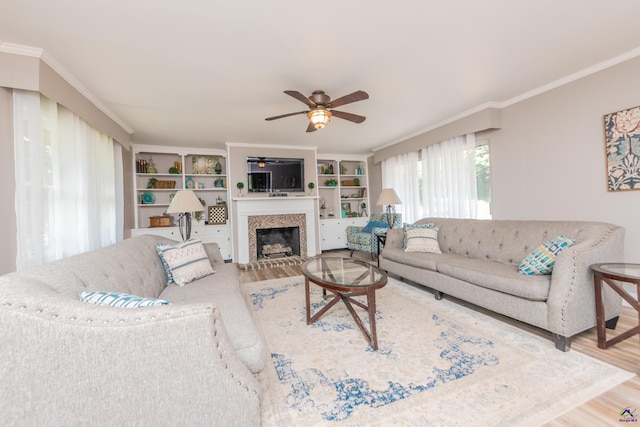 826 Edward Pl, Macon, GA 31204 - living area featuring wood finished floors, a glass covered fireplace, a ceiling fan, and crown molding