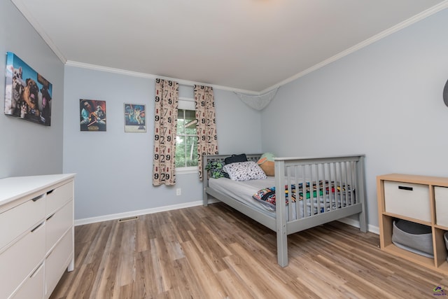 826 Edward Pl, Macon, GA 31204 - bedroom featuring light wood finished floors, ornamental molding, and baseboards