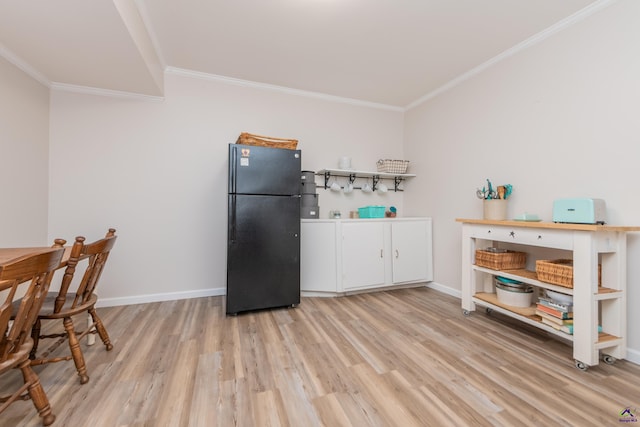 826 Edward Pl, Macon, GA 31204 - kitchen with freestanding refrigerator, ornamental molding, light wood-style flooring, baseboards, and white cabinetry