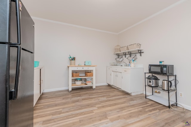 826 Edward Pl, Macon, GA 31204 - laundry room with ornamental molding, light wood-style flooring, and baseboards