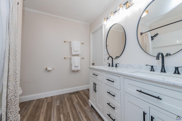826 Edward Pl, Macon, GA 31204 - bathroom with crown molding, double vanity, wood finished floors, toilet, and baseboards