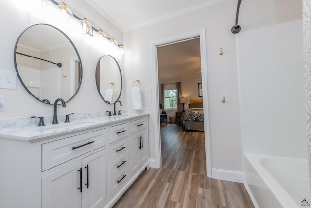 826 Edward Pl, Macon, GA 31204 - ensuite bathroom featuring wood finished floors, double vanity, ornamental molding, bathtub / shower combination, and baseboards