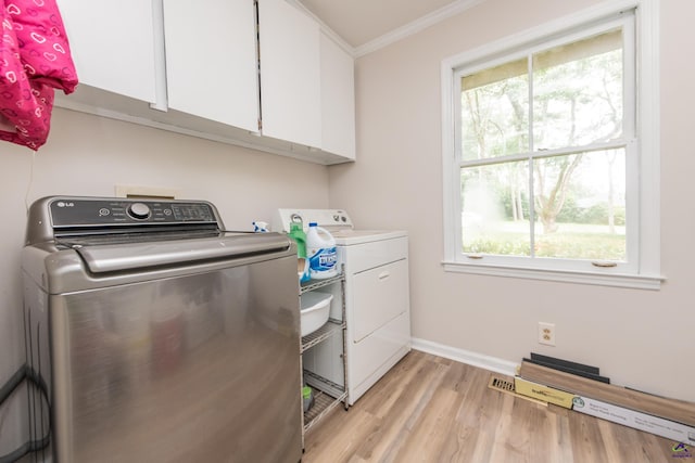 826 Edward Pl, Macon, GA 31204 - washroom featuring washing machine and dryer, cabinet space, crown molding, healthy amount of natural light, and light wood-style floors
