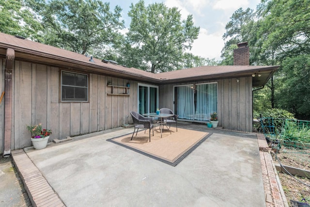 826 Edward Pl, Macon, GA 31204 - back of house featuring a patio area, board and batten siding, a chimney, and outdoor dining space