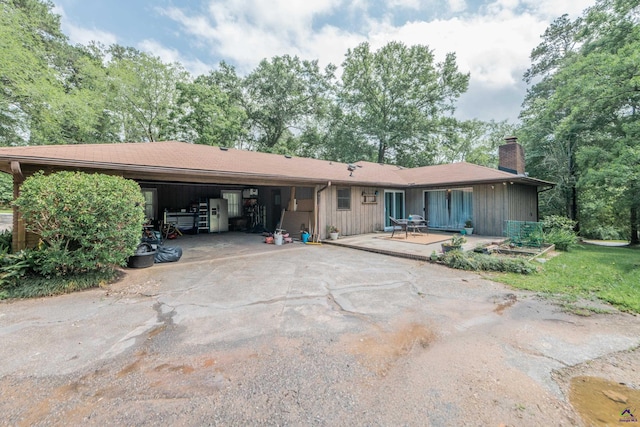826 Edward Pl, Macon, GA 31204 - ranch-style house with a chimney, driveway, a wooden deck, a garage, and a carport