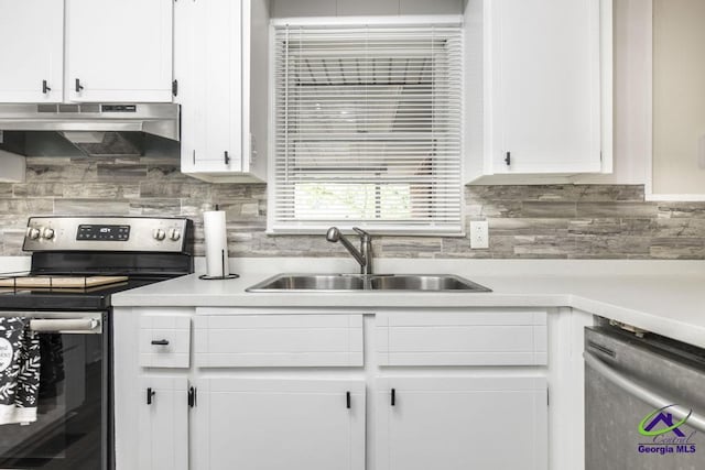 123 Robinhood Dr, Warner Robins, GA 31088 - kitchen with appliances with stainless steel finishes, under cabinet range hood, a sink, and white cabinetry