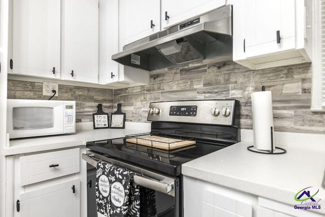 123 Robinhood Dr, Warner Robins, GA 31088 - kitchen featuring electric stove, white microwave, under cabinet range hood, decorative backsplash, and light countertops