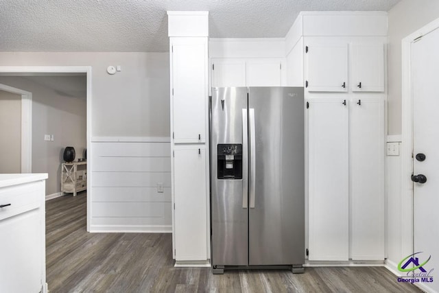 123 Robinhood Dr, Warner Robins, GA 31088 - kitchen featuring stainless steel fridge with ice dispenser, dark wood-style flooring, white cabinetry, a textured ceiling, and light countertops