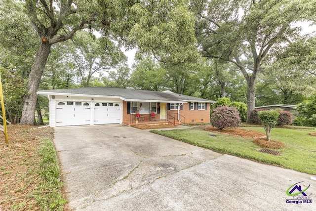 123 Robinhood Dr, Warner Robins, GA 31088 - ranch-style house featuring a porch, driveway, a garage, a front yard, and brick siding