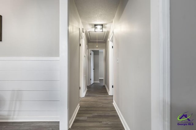 123 Robinhood Dr, Warner Robins, GA 31088 - hallway with attic access, dark wood-type flooring, baseboards, and a textured ceiling
