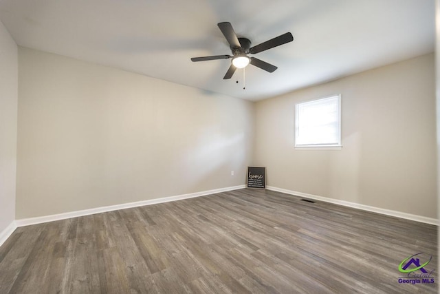 123 Robinhood Dr, Warner Robins, GA 31088 - unfurnished room featuring dark wood-type flooring, baseboards, and a ceiling fan