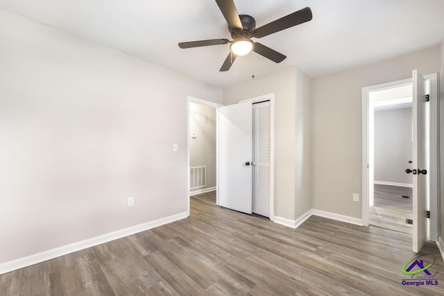 123 Robinhood Dr, Warner Robins, GA 31088 - unfurnished bedroom featuring wood finished floors, a closet, baseboards, and a ceiling fan