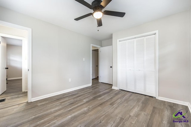 123 Robinhood Dr, Warner Robins, GA 31088 - unfurnished bedroom with wood finished floors, baseboards, a closet, and a ceiling fan