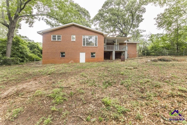 123 Robinhood Dr, Warner Robins, GA 31088 - back of house featuring ceiling fan, brick siding, and a balcony