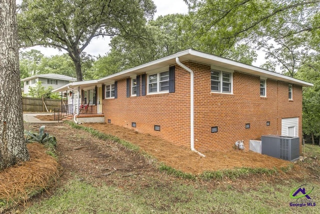 123 Robinhood Dr, Warner Robins, GA 31088 - view of home's exterior featuring crawl space, cooling unit, covered porch, and brick siding