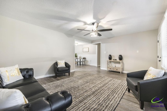 123 Robinhood Dr, Warner Robins, GA 31088 - living room featuring a ceiling fan, wood finished floors, baseboards, and a textured ceiling