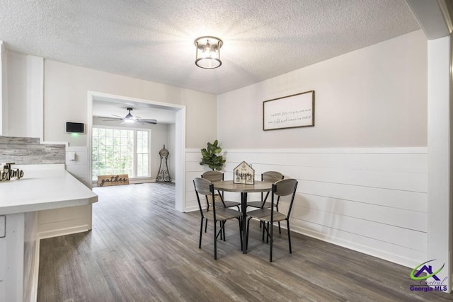 123 Robinhood Dr, Warner Robins, GA 31088 - dining area featuring a textured ceiling, a wainscoted wall, dark wood finished floors, and ceiling fan
