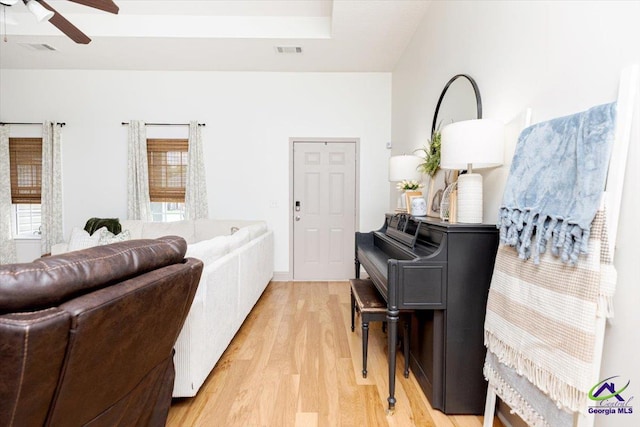 133 Gage Dr, Perry, GA 31069 - living room featuring light wood finished floors, ceiling fan, and a tray ceiling