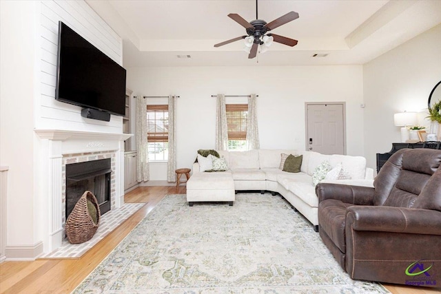 133 Gage Dr, Perry, GA 31069 - living room featuring a ceiling fan, light wood finished floors, and a tray ceiling