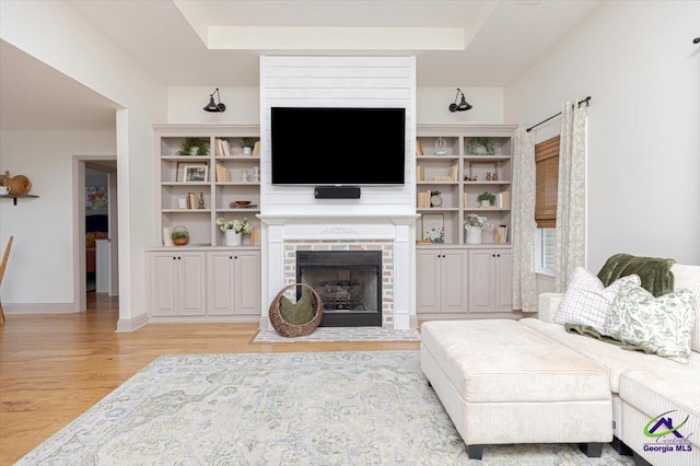 133 Gage Dr, Perry, GA 31069 - living room featuring light wood-type flooring, a fireplace with raised hearth, and baseboards