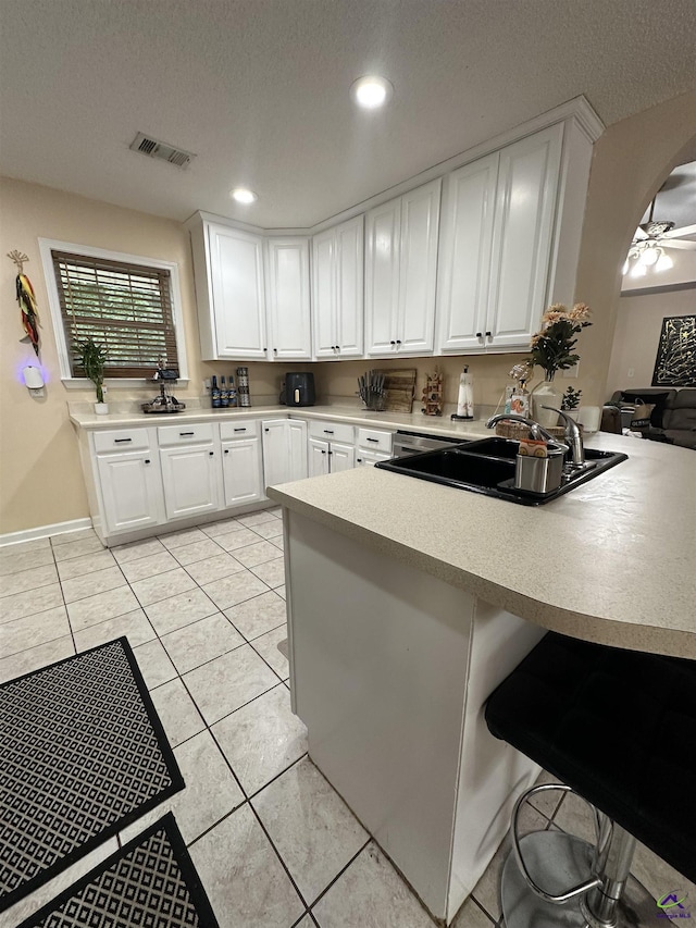 108 Christine, Perry, GA 31069 - kitchen with a sink, light tile patterned flooring, white cabinetry, a peninsula, and recessed lighting