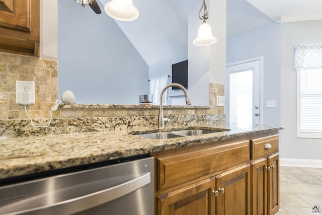 307 George Francis Ct, Bonaire, GA 31005 - kitchen with dishwasher, a sink, tasteful backsplash, light stone countertops, and brown cabinetry