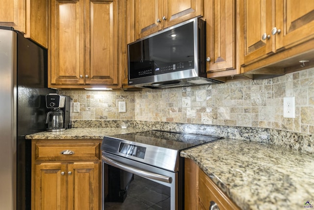 307 George Francis Ct, Bonaire, GA 31005 - kitchen with appliances with stainless steel finishes and brown cabinetry