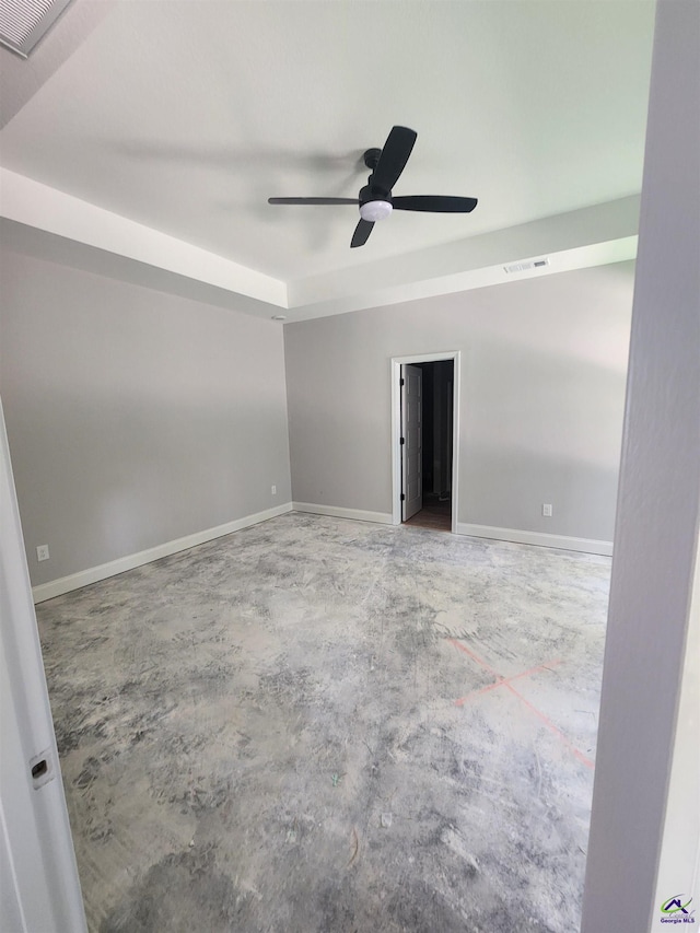 109 Silver Maple Ct, Byron, GA 31008 - unfurnished room with concrete flooring, a ceiling fan, baseboards, and a raised ceiling